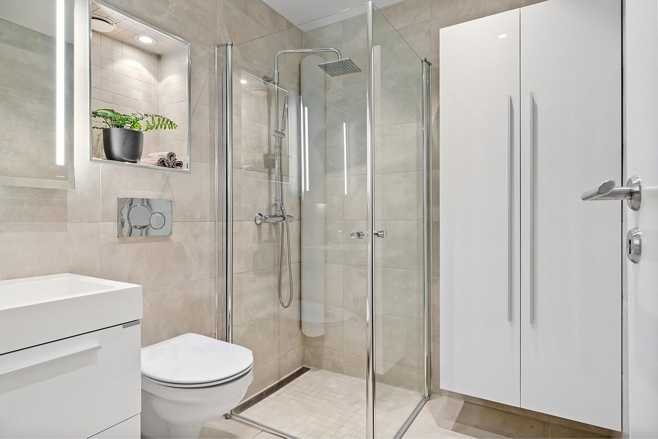 Modernes Bad mit bodennaher Dusche hinter einer Glaswand